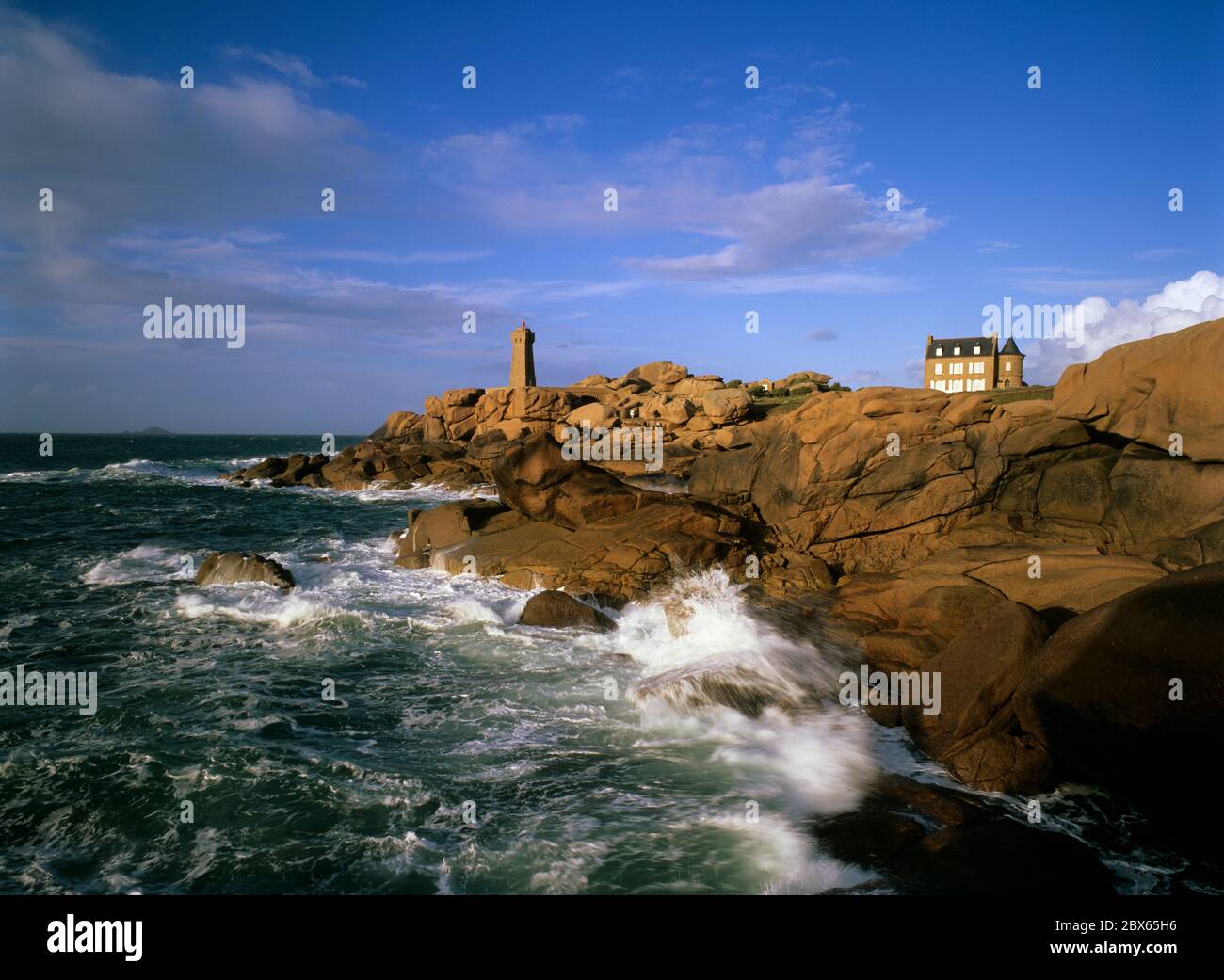 Lighthouse above stormy sea on the Pink Granite Coast, Ploumanac`h, Cotes d`Armor, Brittany, France Stock Photo